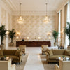 Davenport Print Golden | Kravet - Hotel Lobby Visualization (AI-generated, may not be to scale. Verify pattern scale with product specifications.)