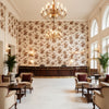 De La Tour Brown | Kravet - Hotel Lobby Visualization (AI-generated, may not be to scale. Verify pattern scale with product specifications.)