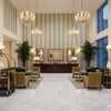 Fisher Stripe Lake/Sand | Kravet - Hotel Lobby Visualization (AI-generated, may not be to scale. Verify pattern scale with product specifications.)