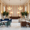 Davies Stripe Petal/Kiwi | Kravet - Hotel Lobby Visualization (AI-generated, may not be to scale. Verify pattern scale with product specifications.)