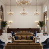 Ultrasuede Green beige | Kravet - Hotel Lobby Visualization (AI-generated, may not be to scale. Verify pattern scale with product specifications.)