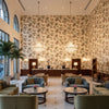 SUSSEX HYDRANGEA Fabrics (AF57848) – Soft Gold | Thibaut - Hotel Lobby Visualization (AI-generated, may not be to scale. Verify pattern scale with product specifications.)
